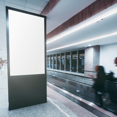 Vertical poster mockup in an airport